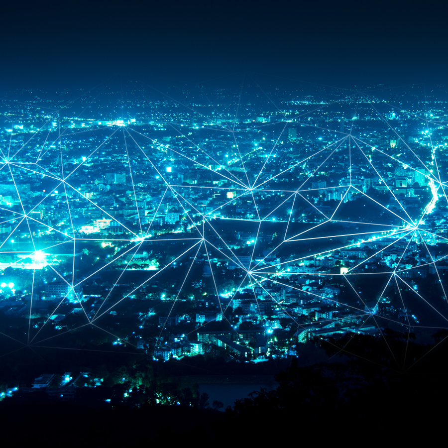 A vibrant network of lights and lines illuminates the cityscape, showcasing urban connectivity and energy at night.