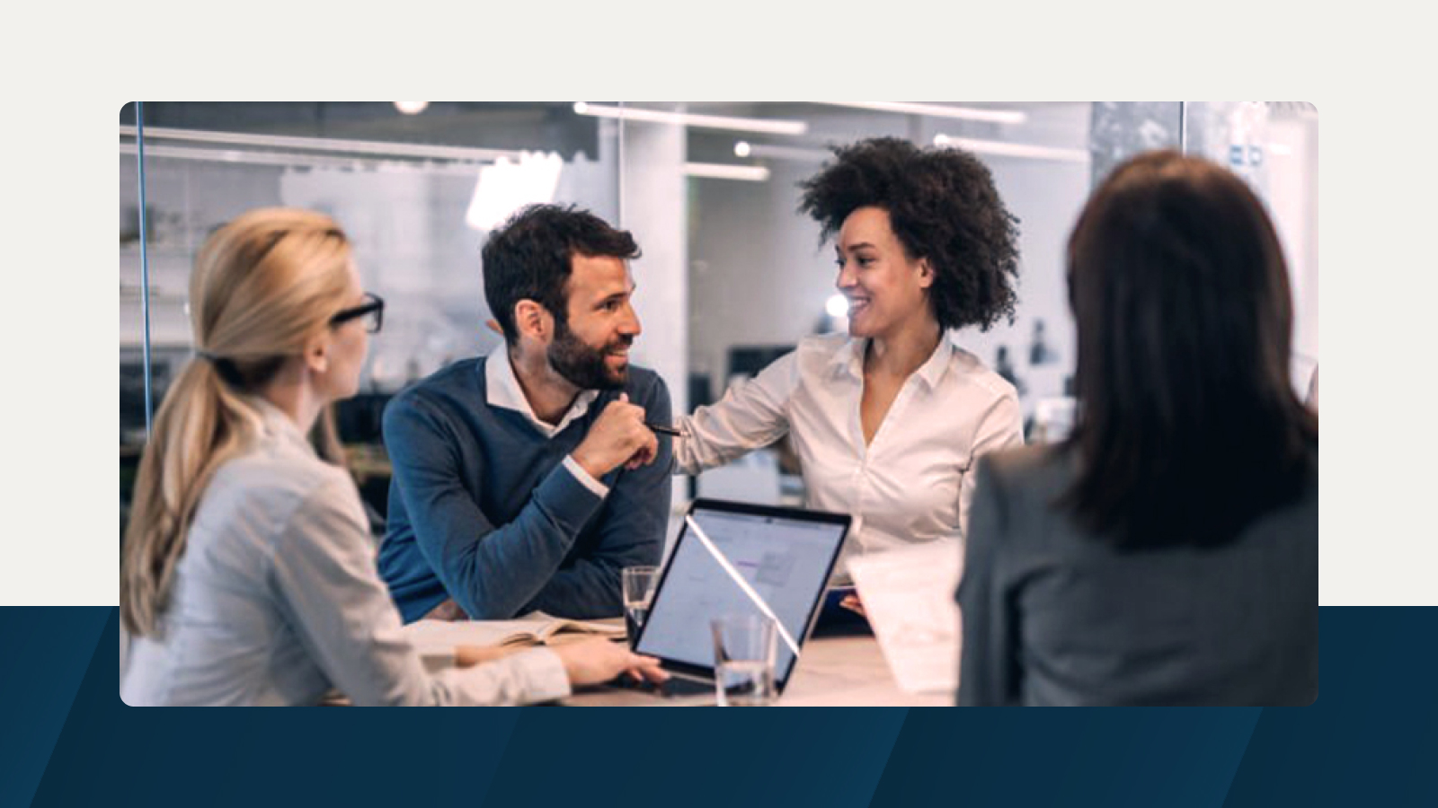 A business meeting in progress, with a group of professionals engaging in a discussion, fostering teamwork and collaboration in a contemporary office setting.