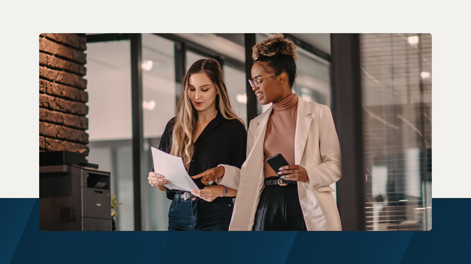 Two professionals discussing a revenue planning document in a modern office setting.