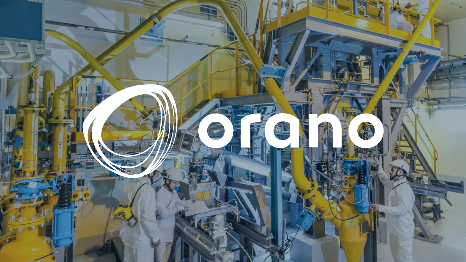 Orano Logo displayed center. Workers in white protective gear operate equipment inside an industrial facility with yellow machinery.